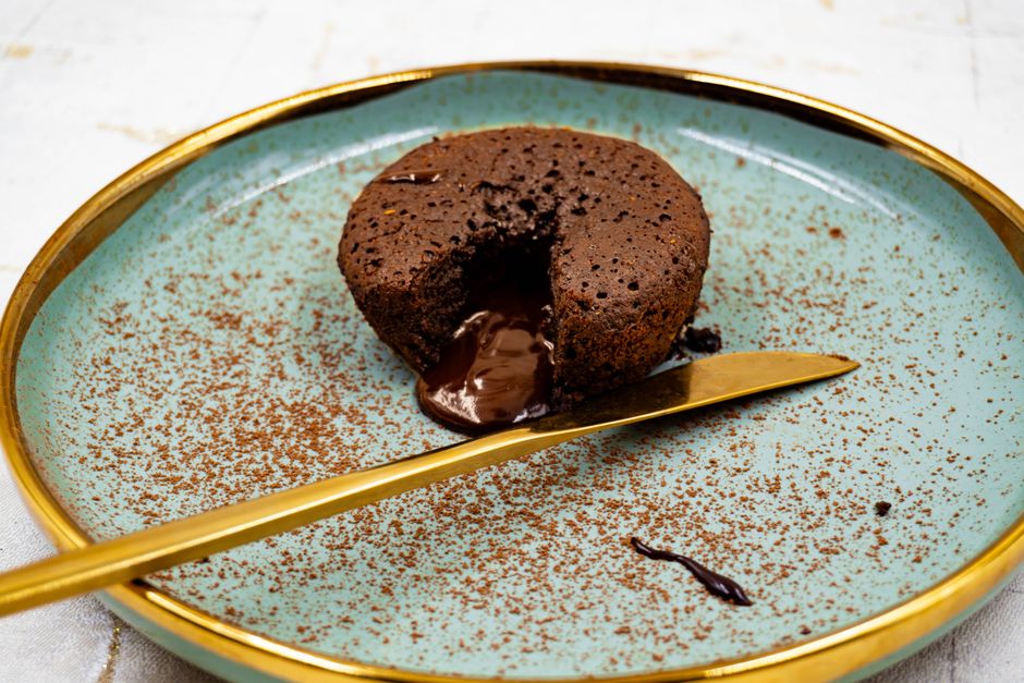 Indulge in a rich chocolate lava cake with molten center, served on a stylish plate.